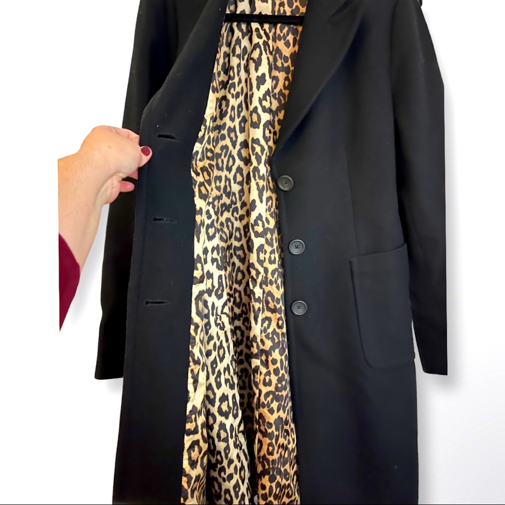 Black coat with leopard print lining.